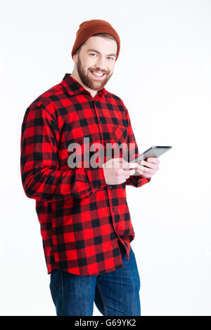 Smilling young hipster guy using pc tablet isolated on the white background Stock Photo