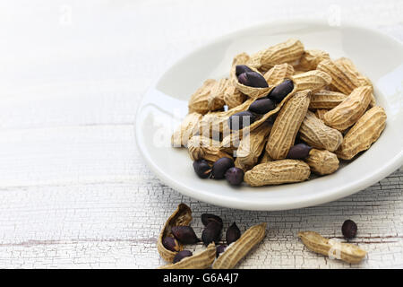 black peanuts on white dish Stock Photo