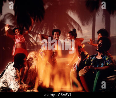 1960s 1970s CARIBBEAN CALYPSO DANCERS AND MUSICIANS AROUND FIRE Stock Photo