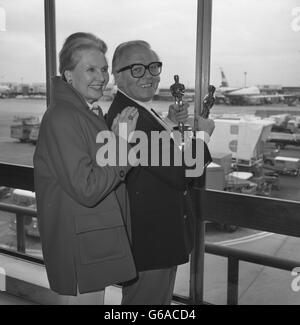 Sir Richard Attenborough arrives at Heathrow Airport with his wife Sheila Sim, holding the Oscars he won for his film Gandhi. Stock Photo