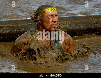 Competitors on the 'Dunking Time' section of the Total Warrior 10 Mile Challenge at Shap Abbey, Cumbria. Stock Photo