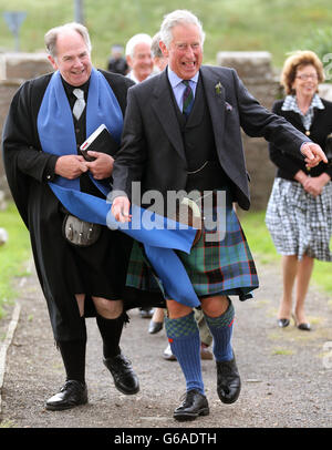 The Prince of Wales with minister Mr Lyall Rennie (left) arriving for a church service at Canisbay Church, Caithness. Stock Photo