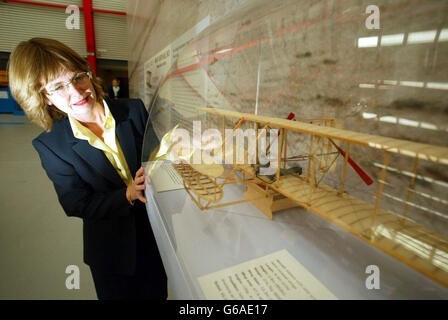 Martha Wright Crouch, great, great niece of aviation pioneers the Wright brothers opens an exhibition to mark the 100th anniversary of her ancestors' first historic flight. Mrs Wright Crouch , 48, of Linton, Cambridgeshire, and her daughter Sarah, 16, *..were at the aviation branch of the Imperial War Museum at Duxford, Cambridgeshire, to celebrate the first manned, powered, controlled flight. She is pictured looking at a model of the Kitty Hawk. Stock Photo