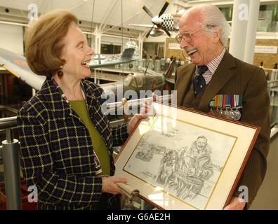 Battle of Britain veteran Flight Lieutenant Jack Toombs, 84 from High Wycombe shows a drawing of himself to Lady Dowding, daughter in law of the late Air Chief Marshal Sir Hugh Dowding, at the Imperial War Museum in central London. *...Lady Dowding visited the museum to meet veterans to mark the launch of a series of drawings of Battle of Britain airmen, by artist Rog Rogers. Proceeds from the sale of the prints, signed by the subjects will go on towards the battle of Britain London Monument. Stock Photo