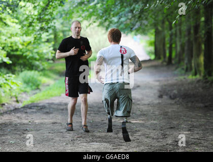 Lance Bombardier James Simpson of the Royal Artillery with head coach Michael Cohen during a training session in woods near Otley, Leeds ahead, of the Spartan Race he is competing in September. Stock Photo