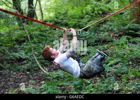 Lance Bombardier James Simpson of the Royal Artillery during a training session in woods near Otley, Leeds, ahead of the Spartan Race he is competing in September. Stock Photo