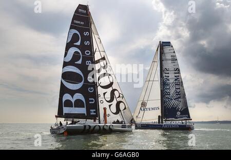 Alex Thomson's Open 60 racing yacht Hugo Boss and Brian Thompson's Artemis Ocean Racing during the Artemis Challenge at Aberdeen Asset Management Cowes Week. Stock Photo