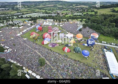 hot air balloons inflating as they prepare to launch at the Bristol International Balloon Fiesta 2013, where balloon pilots from all over the world have gathered in Ashton Court Estate, Bristol for the four day festival. 10/08/13 Stock Photo