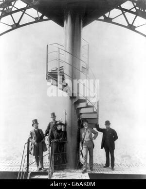Gustave Eiffel and four other people at the summit of the Eiffel Tower at the time of the Paris Exposition Universelle in 1889, for which the tower was built. Stock Photo