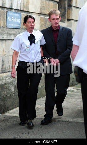 Luke Carey, 24, (right) is led away from York Crown Court after he was was jailed for six years and five months today for supplying a Class A drug to a teenage girl who died after taking the substance. Stock Photo