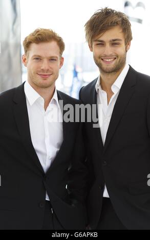 Actors Douglas Booth (right) and Sam Reid before the Artemis Challenge at Aberdeen Asset Management Cowes Week where they sailed onboard the Open 60 racing yacht, Hugo Boss, with round the world yachtsman Alex Thomson. Stock Photo