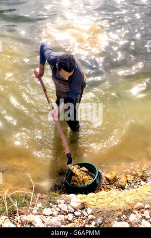 Gold digger in France in the region of Cevennes and the department of Gard in the middle of the river called Le Gardon Stock Photo