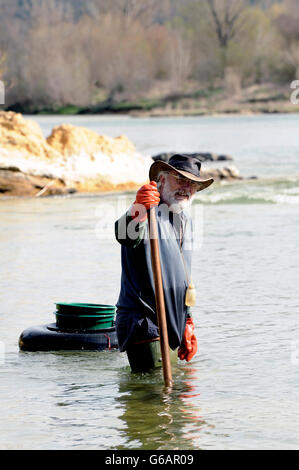 Gold digger in France in the region of Cevennes and the department of Gard in the middle of the river called Le Gardon Stock Photo