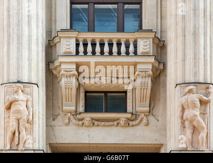 Old building exterior with balcony, columns and bas relief closeup. Vorosmarty ter square, Belvaros, central Budapest, Hungary, Stock Photo