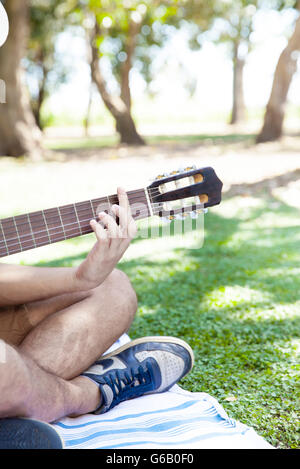 Man playing acoustic guitar Stock Photo