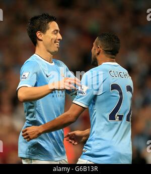 Manchester City's Samir Nasri (left) celebrates with his team-mate Gael Clichy (right) after scoring his team's fourth goal Stock Photo