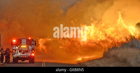 Firefighters from the Lompoc City Fire Department take shelter behind their engine Thursday night, June 16, 2016, as wind driven flames advance from the Sherpa Fire. The flames were crossing Calle Real near El Capitan State Park in Santa Barbara County. 16th June, 2016. © © /ZUMA Wire/Alamy Live News Stock Photo