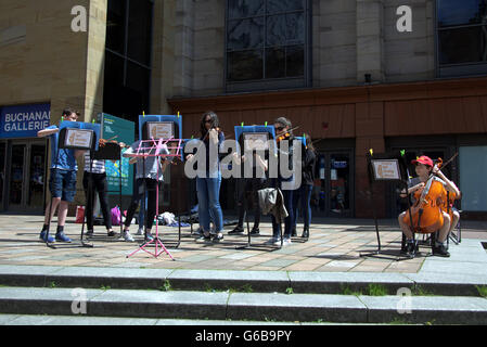 Glasgow, Scotland, UK. 23rd June, 2016. On the day of the Brexit vote The Glasgow Gaelic School ironically perform to finance their class European trip in the shadow of Donald Dewar, the father of the Scottish devolution. Credit:  Gerard Ferry/Alamy Live News Stock Photo