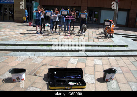 Glasgow, Scotland, UK. 23rd June, 2016. On the day of the Brexit vote The Glasgow Gaelic School ironically perform to finance their class European trip in the shadow of Donald Dewar, the father of the Scottish devolution. Credit:  Gerard Ferry/Alamy Live News Stock Photo