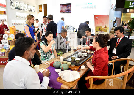 Beijing, China. 24th June, 2016. India merchants taste Pu'er tea during the Beijing International Tea Expo in Beijing, capital of China, June 24, 2016. The four-day tea expo kicked off here Friday. Credit:  Li Xin/Xinhua/Alamy Live News Stock Photo