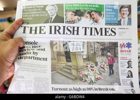 London, UK 24 June 2016 - A reader reads the front page of The Irish Times.         British newspaper front pages coverage on the day after the EU Referendum voting. Credit:  Dinendra Haria/Alamy Live News Stock Photo