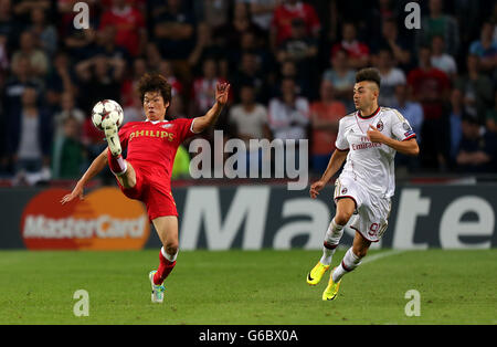 PSV Eindhoven's Park Ji-Sung controls the ball in the air watched by AC Milan's Stephan El Shaarawy Stock Photo