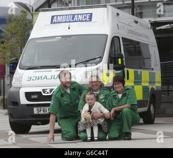 Three-year-old Casey McLean with paramedics left to right Andy Houston, June Maxwell and Julie Grainger, who saved her life after she went into cardio /respiratory arrest in Glasgow. PRESS ASSOCIATION Photo. Picture date: Thursday August 15, 2013. A three-year-old girl has been reunited with paramedics who saved her life as the ambulance service revealed it is getting to life-threatening calls quicker. Casey McLean, from Colston in Glasgow, was resuscitated by ambulance staff after she went into cardio /respiratory arrest before being rushed to hospital, where she was successfully treated. Stock Photo