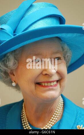 Queen Elizabeth II smiles at waving students while touring the new business school at the City University London. The Queen toured the facility before officially opening it. * 9/5/03: The Royal party were flying into RAF Lossiemouth in Moray, Scotland, where they will visit 14 Squadron and 617 Squadron. At 617 Squadron, Wing Commander David Robertson will introduce veterans from the legendary team to the royal couple who will also meet some of the youngest aircrew and groundcrew members of the current squad. Stock Photo