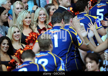 Cheerleaders greet the ACT Brumbles as they celebrate winning the overall Cup at the World Club Sevens at Twickenham Stadium, London. Stock Photo