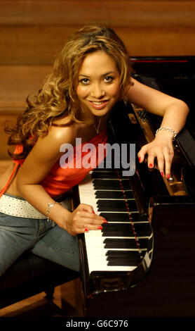 Former Hear'Say singer Myleene Klass, who was classically educated and trained at The Royal Academy of Music, poses at a piano during a photocall to launch her new musical career, signing a six album deal with Universal Classics record label at The Royal Academy of Music, London. Stock Photo