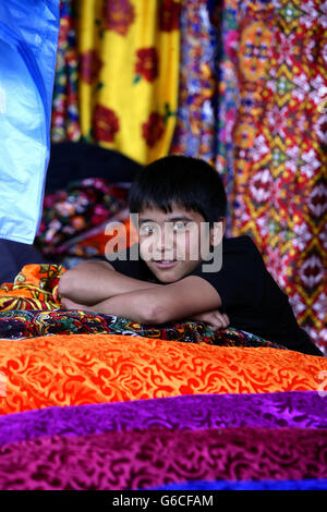 Uzbeki fabric vendor, Urgut market, Samarkand, Uzbekistan Stock Photo