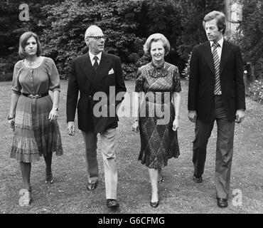 Margaret and Denis Thatcher get away from it all with their 25-year-old twins, Mark and Carol, by strolling through the grounds of Scotney Castle, Kent where Mrs Thatcher has a National Trust flat. She is relaxing before the battle ahead to become the first female Prime Minster. Stock Photo