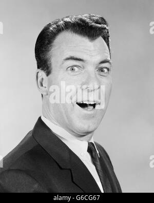 1950s 1960s PORTRAIT LAUGHING SURPRISED BUSINESS MAN LOOKING AT CAMERA Stock Photo