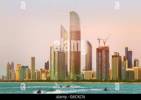 View of Abu Dhabi Skyline at sunset, United Arab Emirates Stock Photo