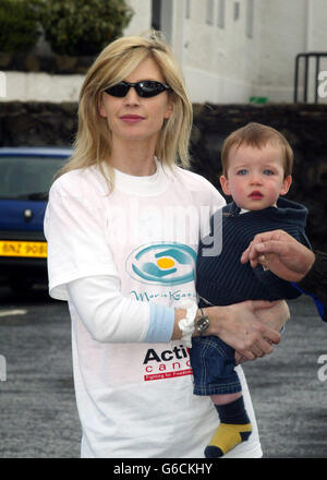Yvonne Keating, wife of singer Ronan Keating, with her nephew Dylan, watch Ronan start his walk of Ireland. Starting at the Giants Causeway in Northern Ireland, to Kinsale in Co Cork in the Irish Republic, the trek is over 300 miles long. *... and aims to raise money for Cancer research. Ronan's mother lost her battle against cancer a number of years ago. Stock Photo
