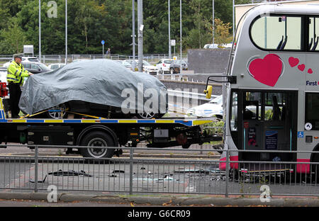 A car involved in a collision with a bus on Grange Road, outside the New Victoria Hospital in Glasgow, is removed from the scene. Stock Photo