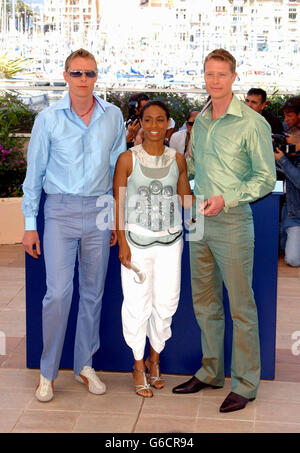 Actress Jada Pinkett-Smith flanked by twin actors Adrien (left) and Neil Rayment pose for photographers during a photocall to promote their new film The Matrix Reloaded at the Palias des Festival as part of the 56th Cannes Film Festival in southern France. Stock Photo