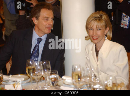 Britain's Prime Minister Tony Blair sits down to dinner with Doris Schroeder, the wife of the German Chancellor Gerhard Schroeder in St Petersburg where world leaders are gathering for the tercentenary of the Russian city. Stock Photo