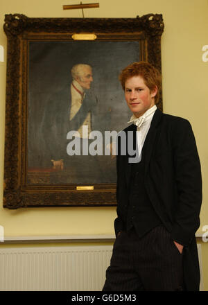 Prince Harry, the younger son of the Prince of Wales, beside a portrait of the Duke of Wellington - the famous victor of the Battle of Waterloo ( 1815). * The portrait hangs in the main hall in Manor House, opposite a miniscule model of Napoleon because the Iron Duke was a boy in a boarding house on this site - the present version of which dates from 1840. The story of the Duke claiming to have won Waterloo 'on the playing fields of Eton' is most possibly apocryphal, but if true would have related not to College Field (the setting of the Wall game) but the gardens at Manor House, where in the Stock Photo