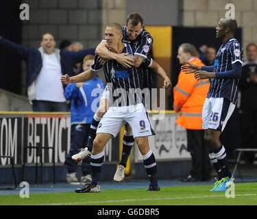 Millwall's Steve Morison (front) celebrates after scoring his sides third goal against Blackpool. Stock Photo