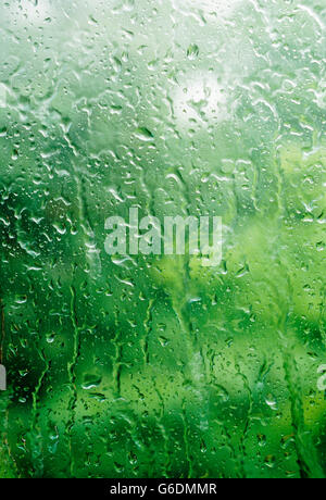 Water droplets beaded up on a glass window in the summer Stock Photo