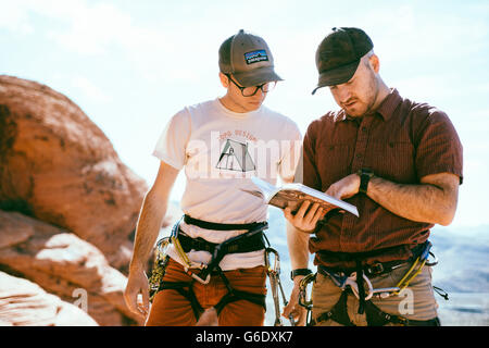 Climbers reading the guide book in Red Rock Canyon, Nevada Stock Photo