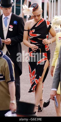 Zara Phillips the daughter of the Princess Royal, pictured as she walks through the Royal enclosure at Ascot on the first day of the Royal Ascot horse race meeting, this afternoon. * Zara, accompanied by her boyfriend , jockey Richard Wilson, (left) turned racegoers heads today as she sported a daring split skirt, in the stunning Gharani Strok black outfit decorated with a pattern of large burnt orange and white flowers. Stock Photo