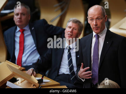 Scottish Finance Secretary John Swinney takes questions after his budget speech at the Scottish parliament in Edinburgh. Stock Photo