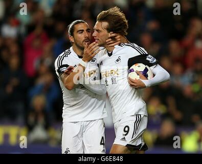 Swansea City's Miguel Michu (right) celebrates with team-mate Chico Flores after scoring his side's second goal of the game Stock Photo