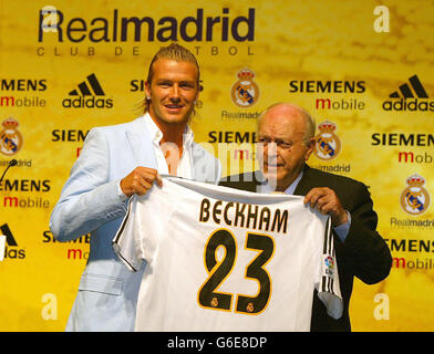 David Beckham (left) holds his new number 23 Real Madrid shirt presented to him by honorary president and former player Alfredo Di Stefano as he is formally unveiled at the basketball stadium next to the club's training ground in Madrid. Stock Photo