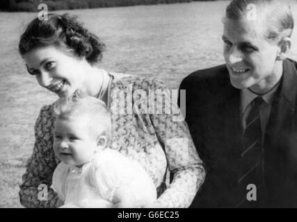 These pictures of eight year old Prince Charles and his Royal parents - Princess Elizabeth and the Duke of Edinburgh - are the most informal ever taken of the baby Prince and his youthful mother and father. These pictures are from a film made for the British Newsreels Association in the grounds of Windlesham Moor, country home in Surrey of Princess Elizabeth and the Duke. PICTURE SHOWS: Family life at its happiest expressed in radiant smiles of Princess Elizabeth, the Duke of Edinburgh and their infant son, Prince Charles. Stock Photo