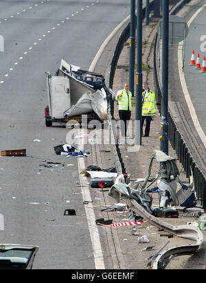 Police start the clear-up operation at the scene on the M56 south of Manchester where a four-vehicle pile-up, left seven people dead and two others fighting for their lives. * The accident, which involved a minibus and three other vehicles, happened close to junction 4 near Wythenshawe. All of those killed and serious injured are believed to have been travelling in the minibus. Stock Photo