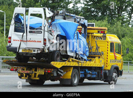 The wreckage of a minibus is secured to a truck after a crash on the M56 in Wythenshawe, Manchester, which left seven people dead and two fighting for their lives. * The minibus, a hotel courtesy taxi, was on its way to Manchester Airport with passengers looking forward to summer holidays. The cause of the crash, which ripped the roof off the minibus and involved another three vehicles, is not yet known but it appears the bus hit the central reservation. Police said the driver was from Manchester and the other 14 passengers were from Herefordshire, Fife, Belfast, Leeds and Tyne and Wear. Stock Photo