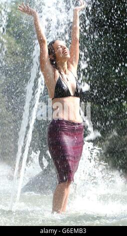 Michal Rockman 26 from Finchley in North London, cools down in the fountain in Hyde Park, central London as the highest ever temperatures in Britain were recorded. Stock Photo